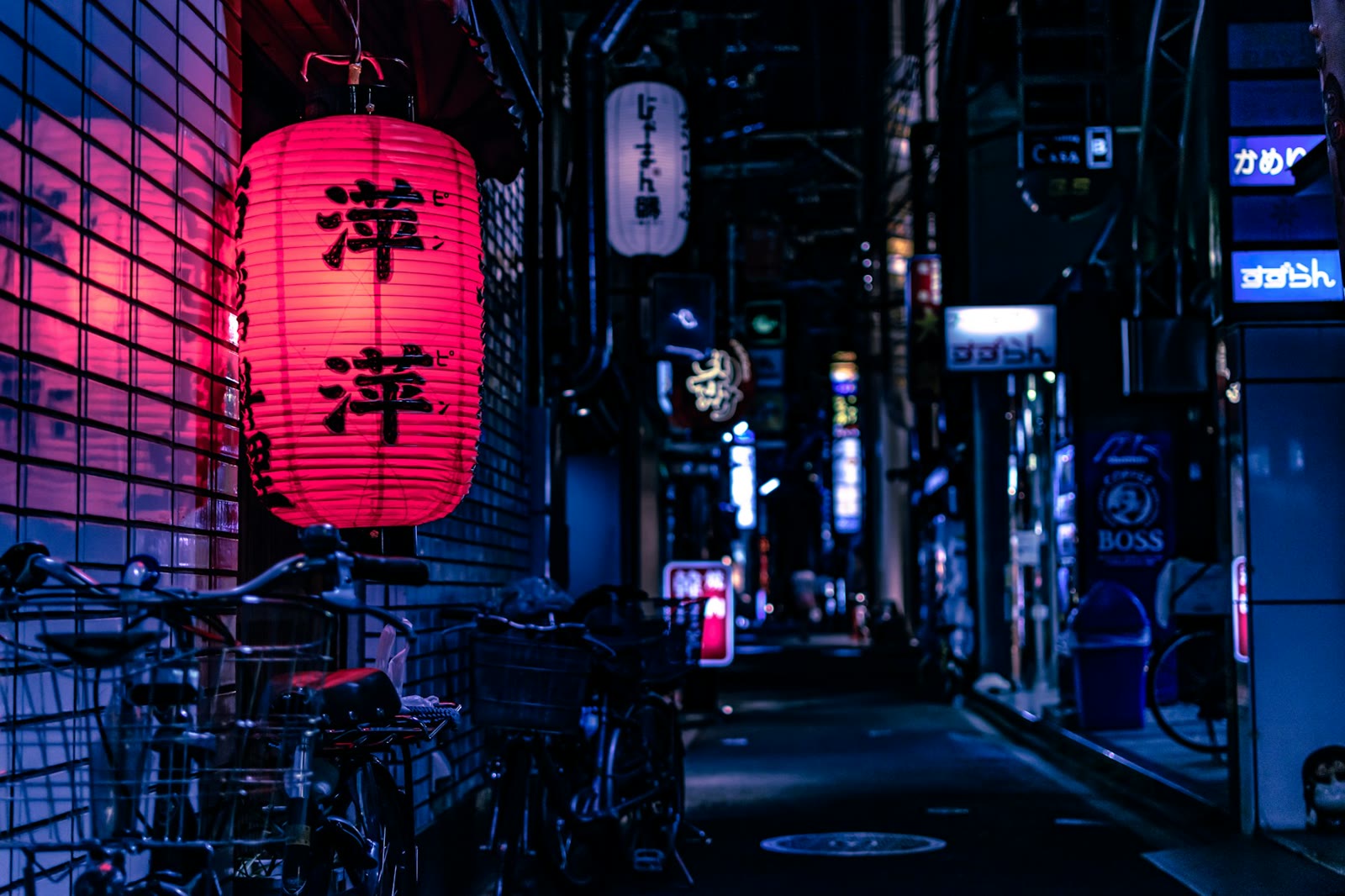 A quiet alley with a red lantern and parked bicycles